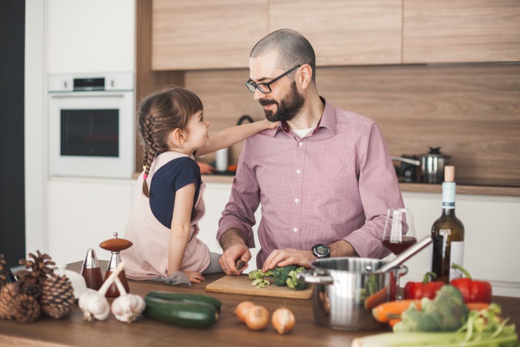 bearded-man-and-his-daughter-are-cooking-vegetable-2022-11-03-05-18-55-utc